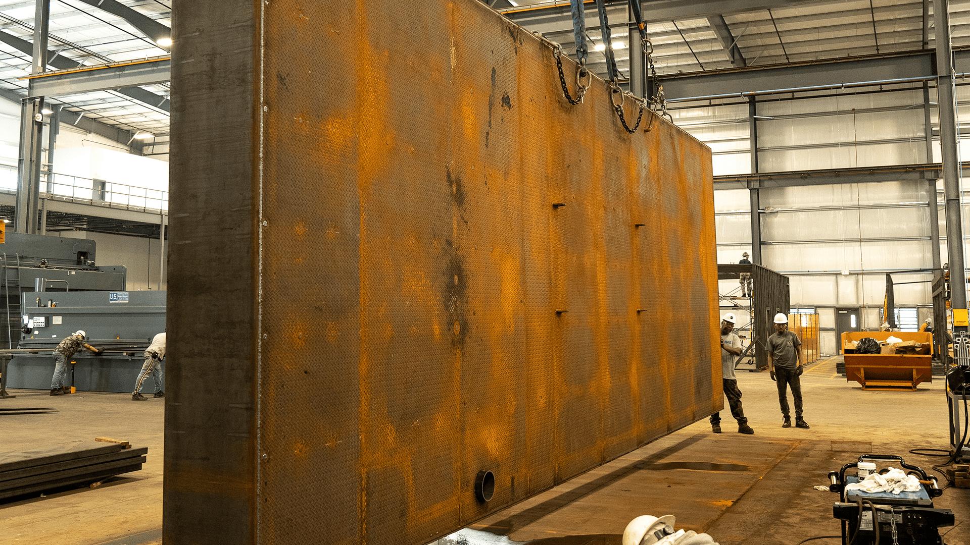 fuel tank being lifted by crane in manufacturing facility Acoustical Sheetmetal Company