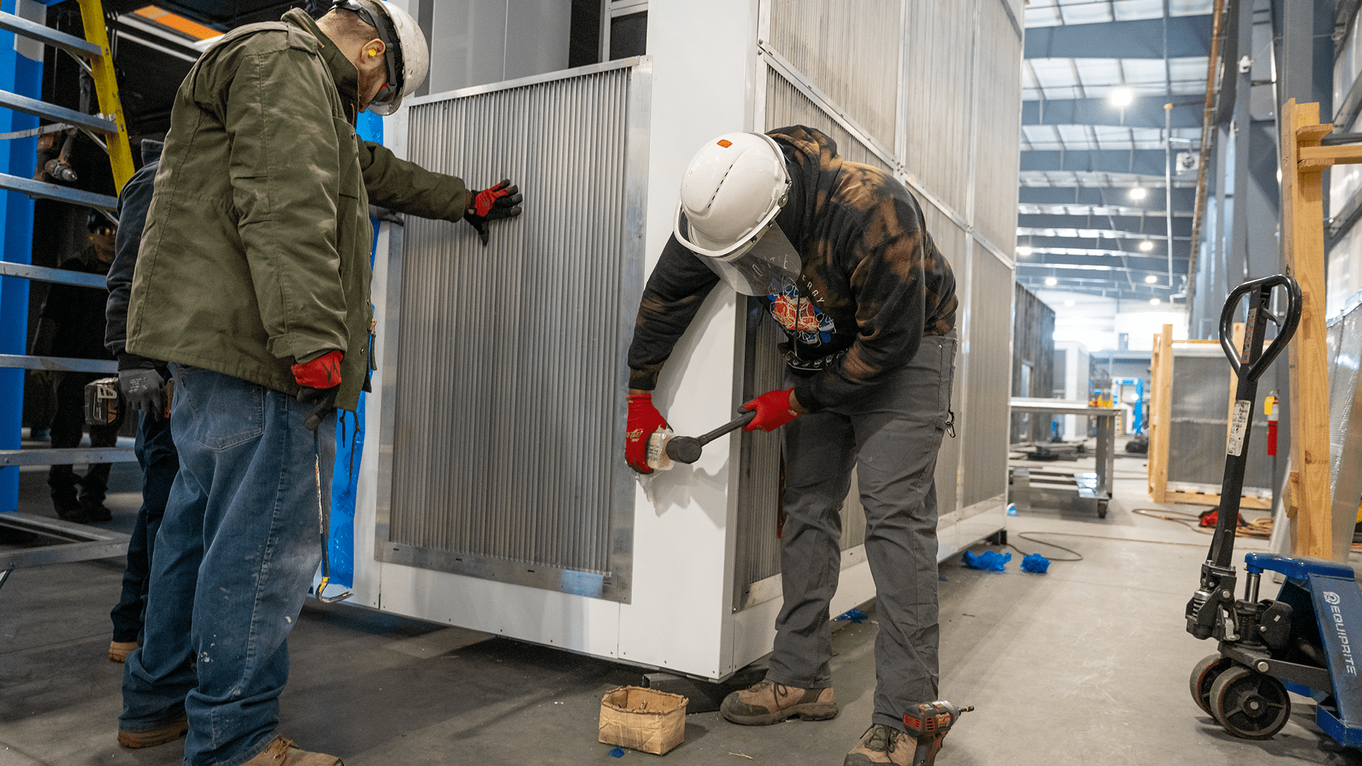 workers assembling vents for enclosure Acoustical Sheetmetal Company
