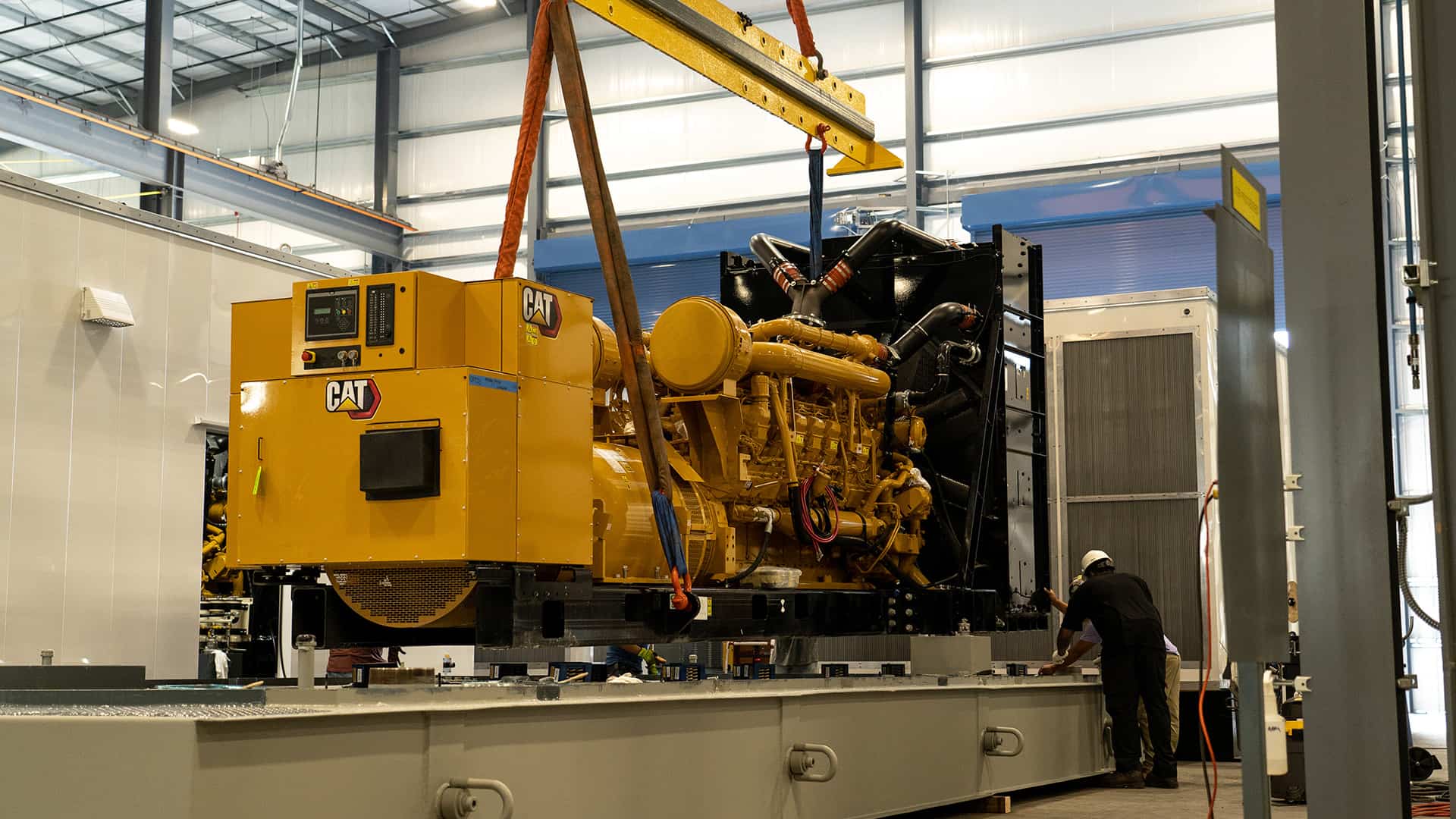 CAT power generator being crane lifted to base tank Acoustical Sheetmetal Company